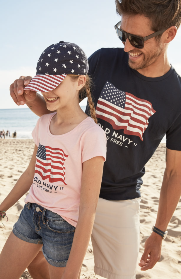 Man and girl on the beach wearing Old Navy flag tees